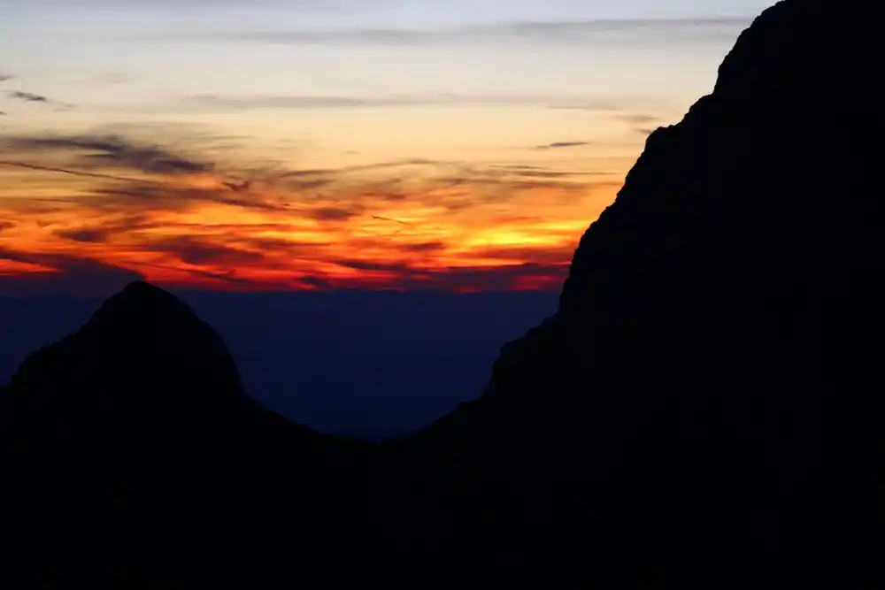 Contre-jour sur les sommets lors d'un crépuscule intense.